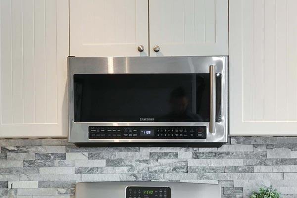 a modern stainless steal stove top and microwave