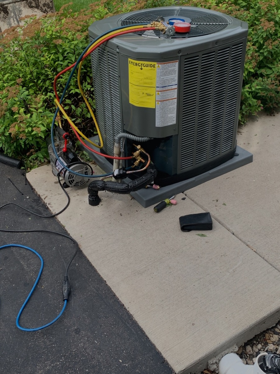 an air conditioner mounted on top of a sidewalk